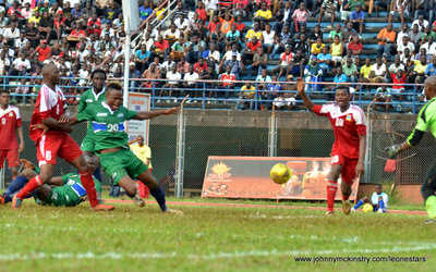The Seychelles pull down Sheriff Suma, conceding a penalty [Leone Stars v Seychelles, Freetown, 19 July 2014 (Pic: Darren McKinstry)]